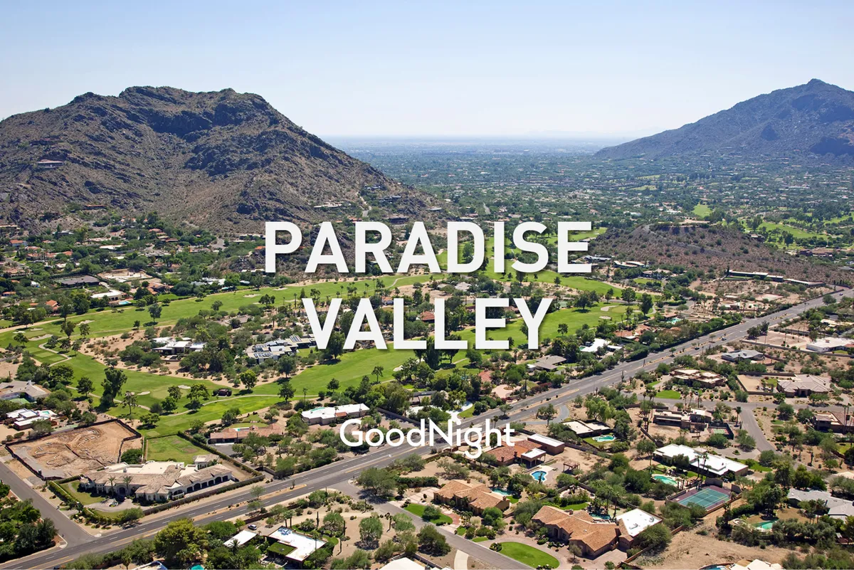 A panoramic view capturing verdant landscapes, rolling golf courses, and majestic mountains that define Paradise Valley's natural beauty. The scenic vantage embraces the region’s tranquil yet vibrant character.